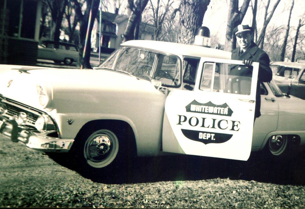 Policeman in an Old Police Car
